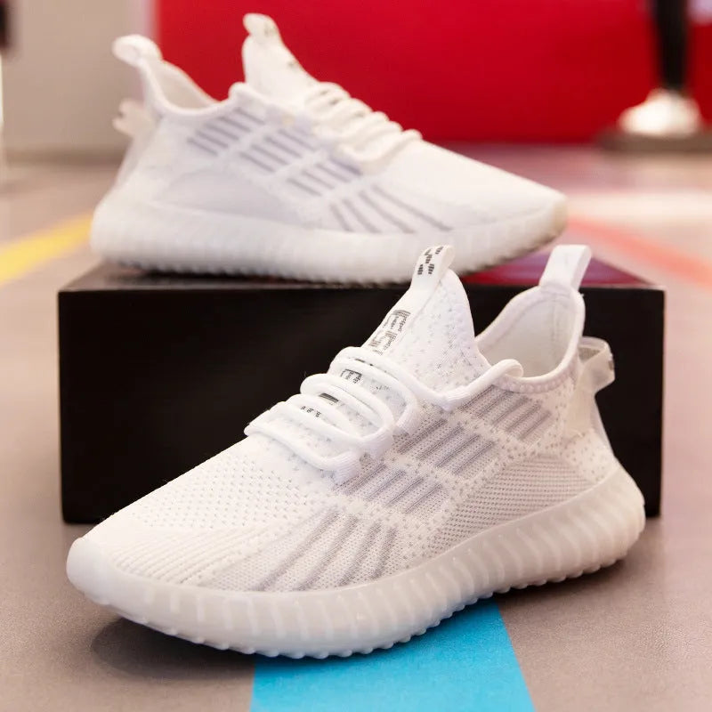 Men's white flying fabric breathable sneakers with mesh lining, round toe and low upper design on a neutral background.