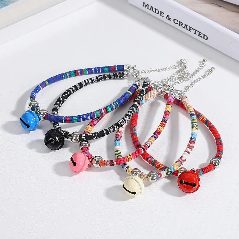Coloured adjustable pet collar with a metal bell and buckle in ethnic style for dogs and cats.