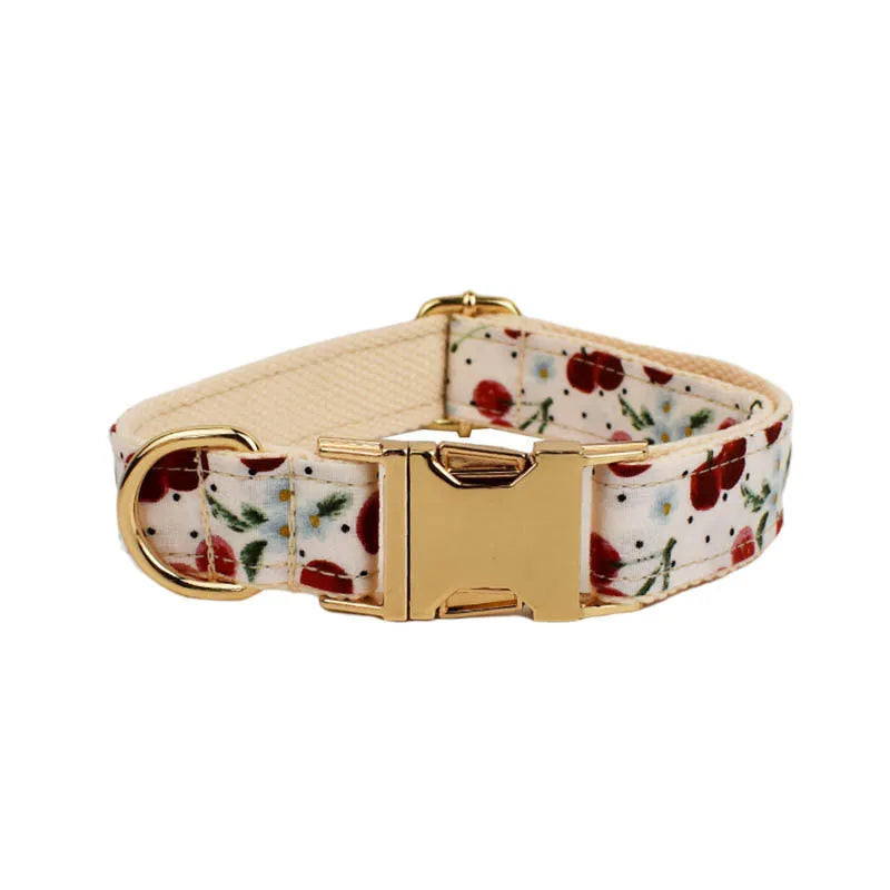 Red cherry print dog collar and leash set with light gold metal buckle and attached cloth bow