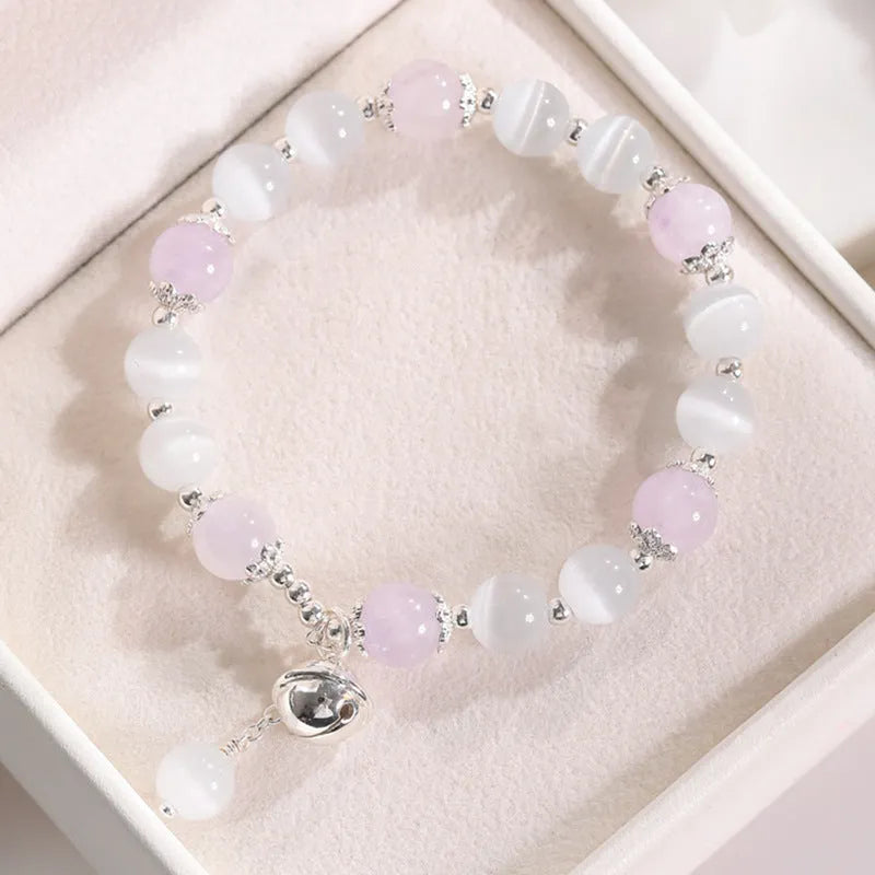 Close-up of a women's electroplated opal cat's eye stone beaded bracelet with diamond-shaped beads.