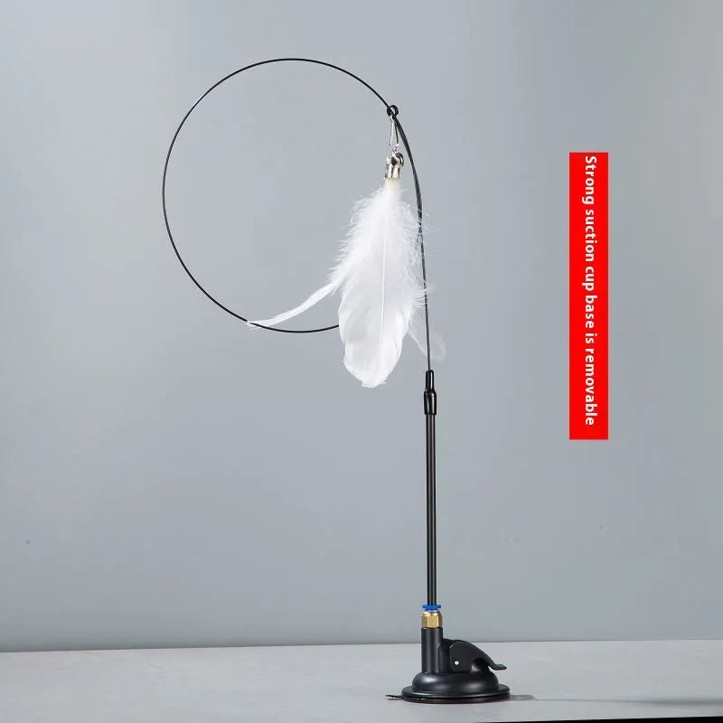 Plastic cat teaser toy with suction cup mount and dangling feather attachment