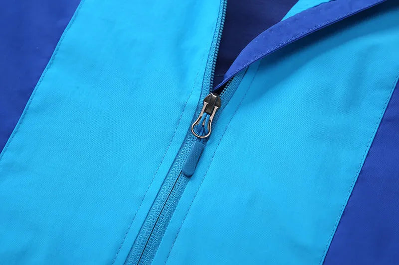 Blue boys' thin autumn jacket with long sleeves and a front zip, laid flat.