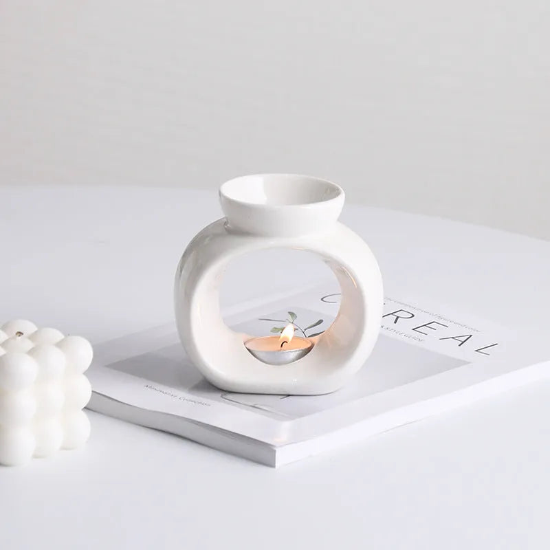 White Nordic style ceramic aromatherapy stove ornament on a wooden surface