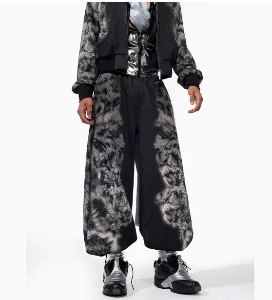 Women's printed loose trousers set in micro-elastic polyester with collage stitching, shown with matching hoodie and shorts.