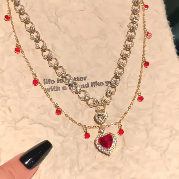 Red alloy double layer necklace with a love heart pendant on a regular chain.
