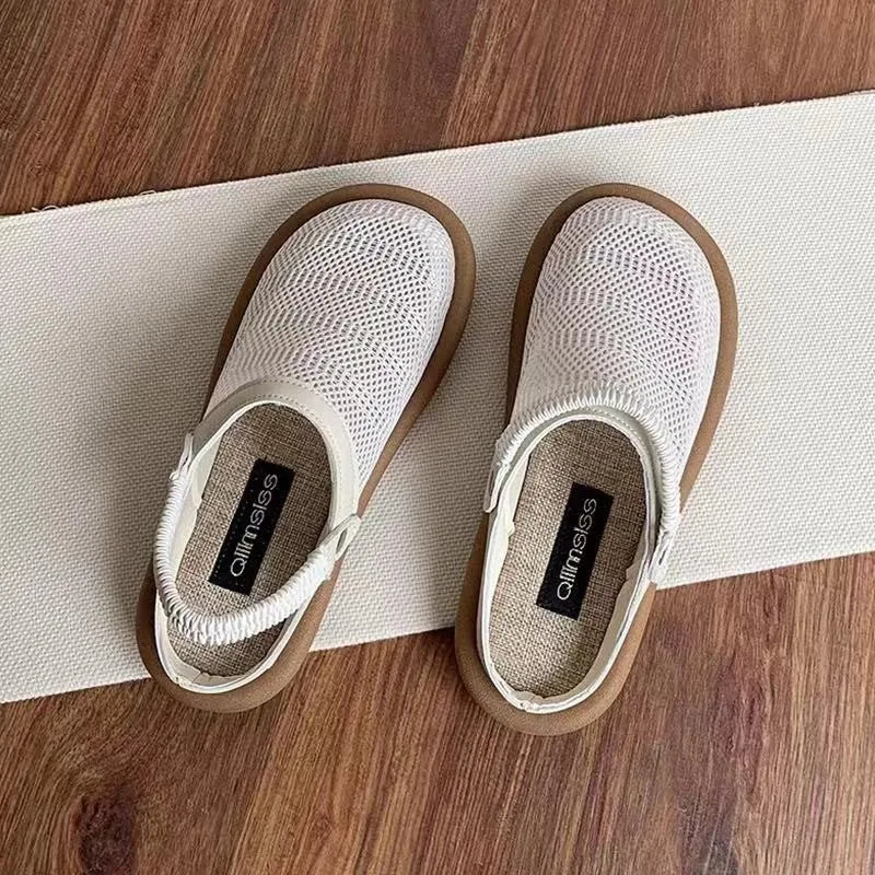 Milky white linen slip-on hole shoes with mesh lining and a light brown rubber sole, shown from the side.