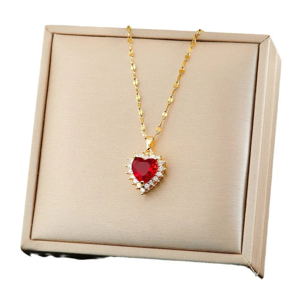 Gold red titanium steel necklace, ear studs, and ring set with hearts and flower pendant designs on a water wave chain.