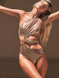 Gold backless one-piece swimsuit for women on a neutral background