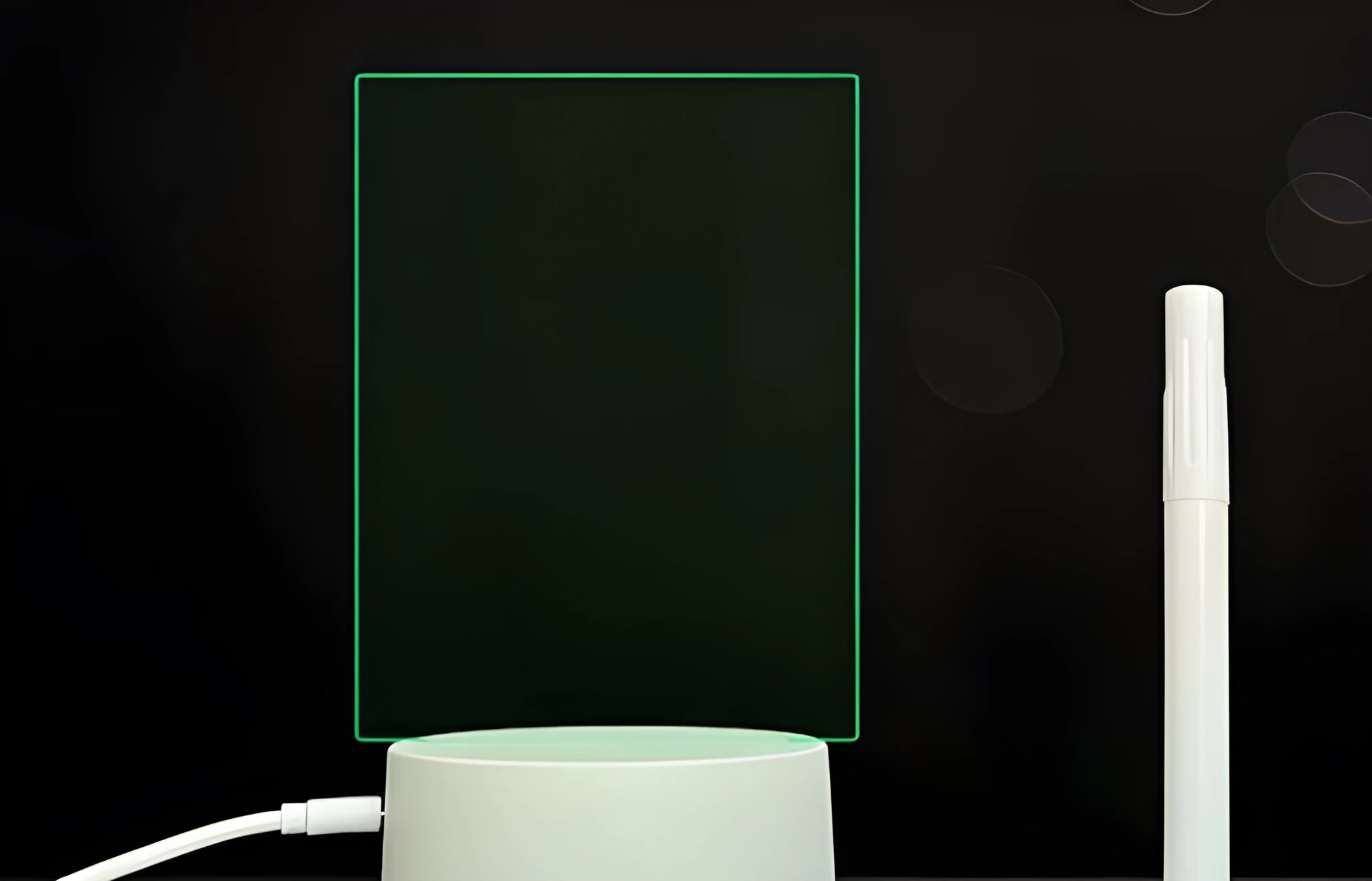 3D acrylic message board night light with remote control and stylus on a desk.