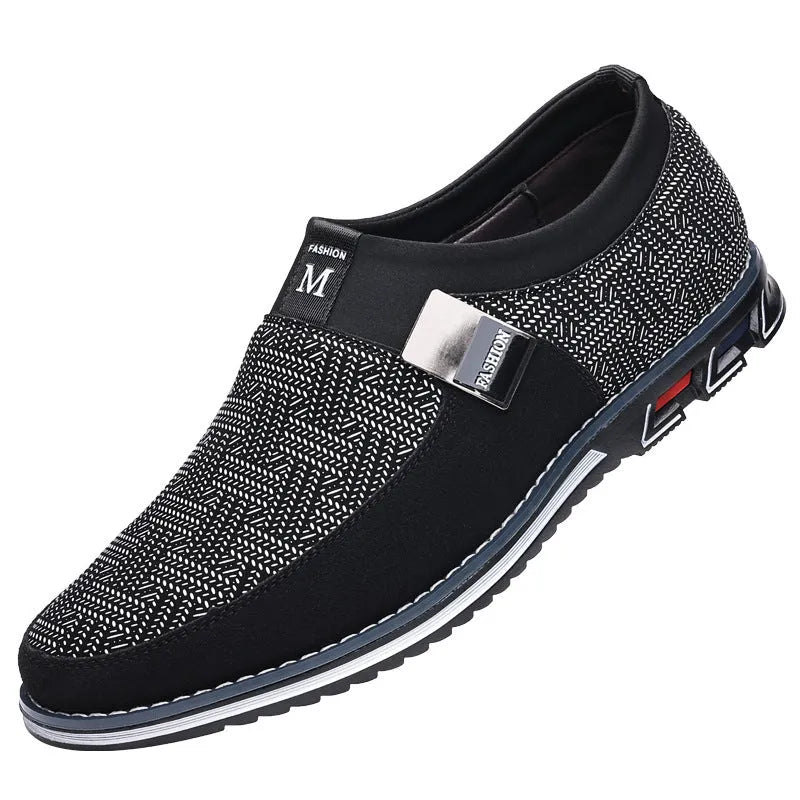 Men's synthetic leather slip-on casual shoe in black, showing square toe and flat rubber sole.