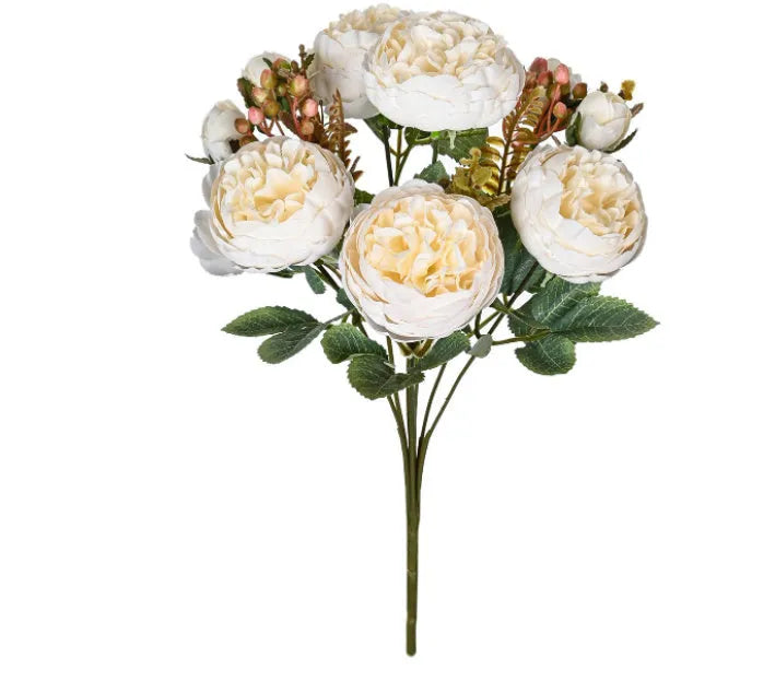 Artificial silk peony bouquet in champagne colour on a table.