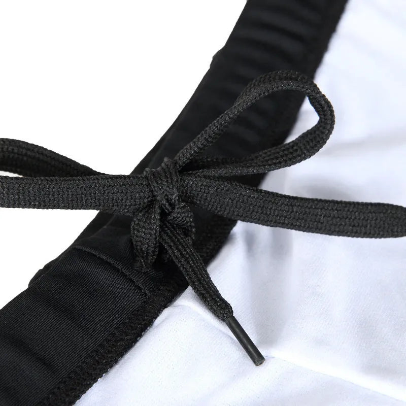 Men's plus size blue fire pattern swimming trunks and cap on a black background.