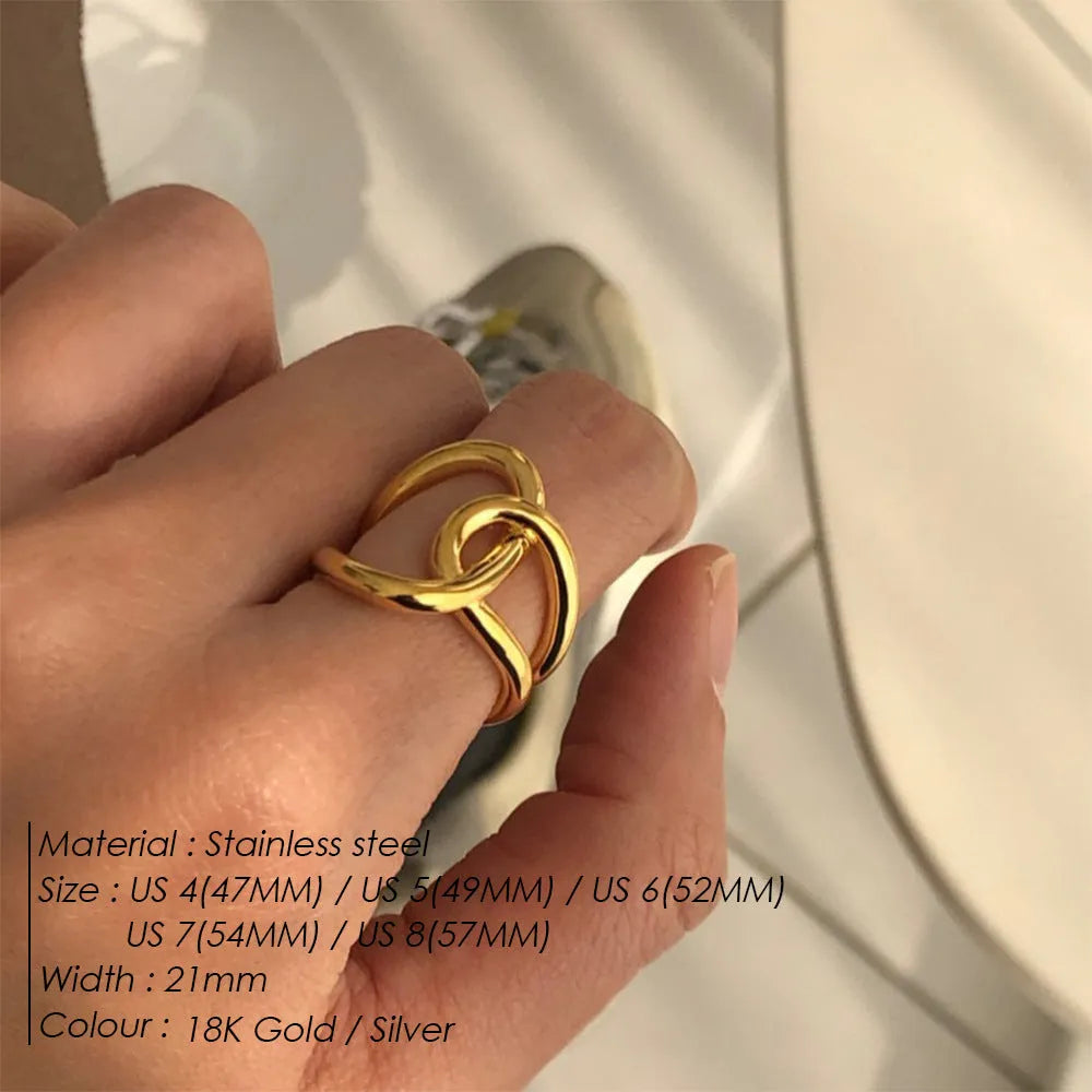 Adjustable knotted opening ring in stainless steel, shown in both gold and steel colour finishes on a woman's hand.