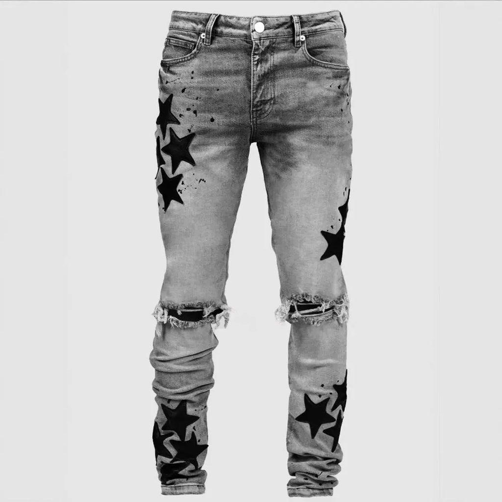 Men's slim blue jeans with embroidery detail on the leg, showing a mid-waist fit.