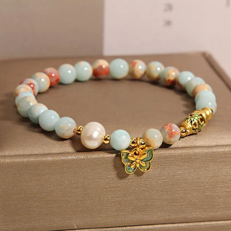 Blue freshwater pearl bracelet with Shoushan stone elements and butterfly pendant.