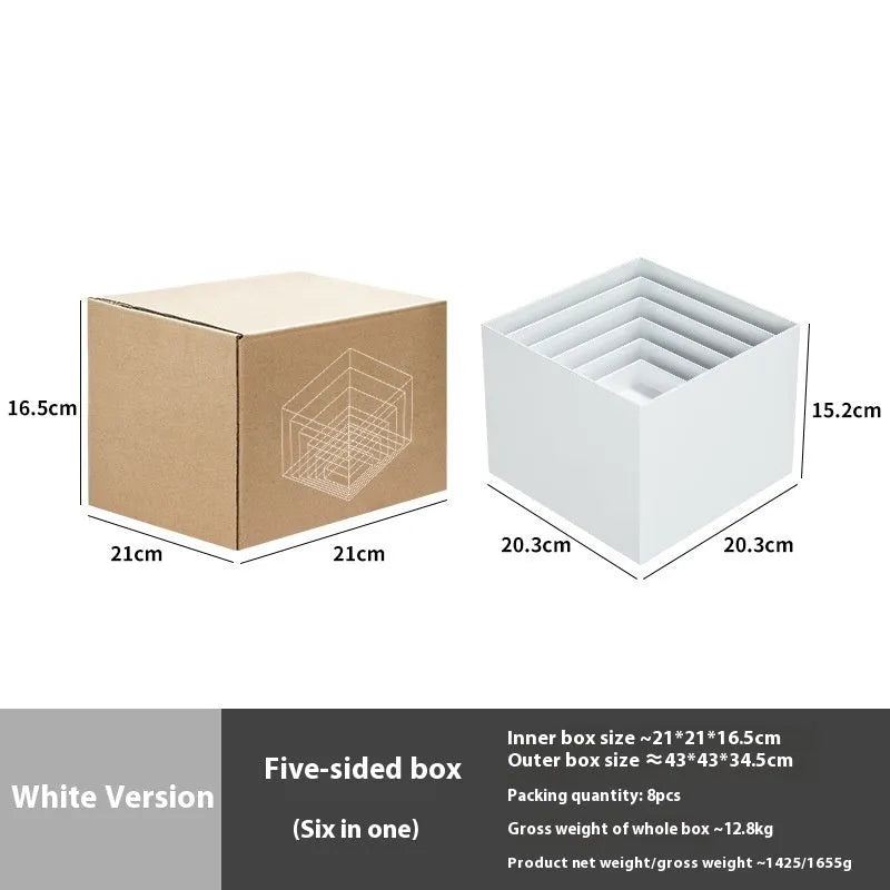 Six white modular plastic cube units arranged as a tiered dessert display stand holding cupcakes.