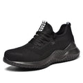 Men's black steel toe cap safety shoes with a low-cut design on a work surface.