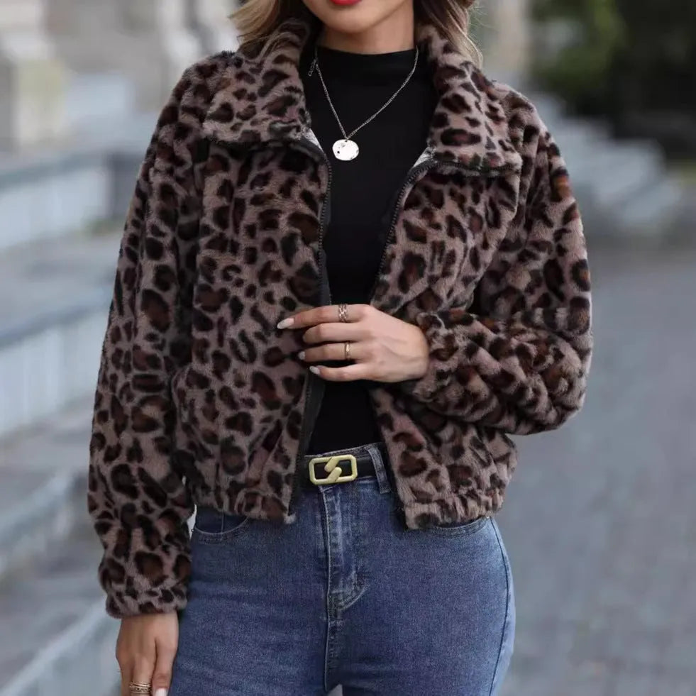 A woman's loose long-sleeve zip-up coat in a plush leopard print fabric with raglan sleeves.