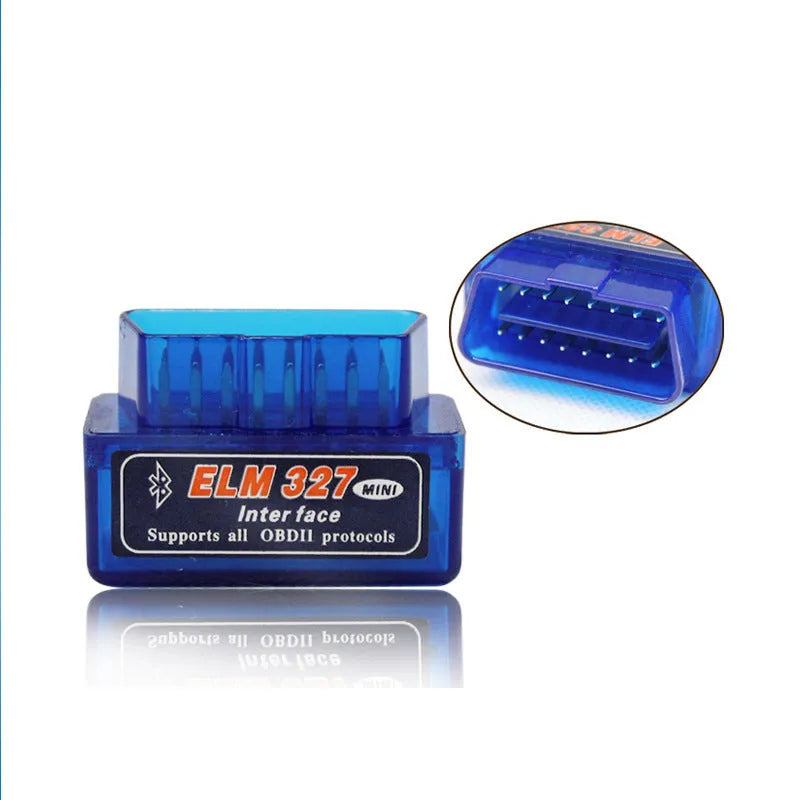 Small black ELM327 OBD2 Bluetooth car diagnostic scanner plugged into a vehicle port.