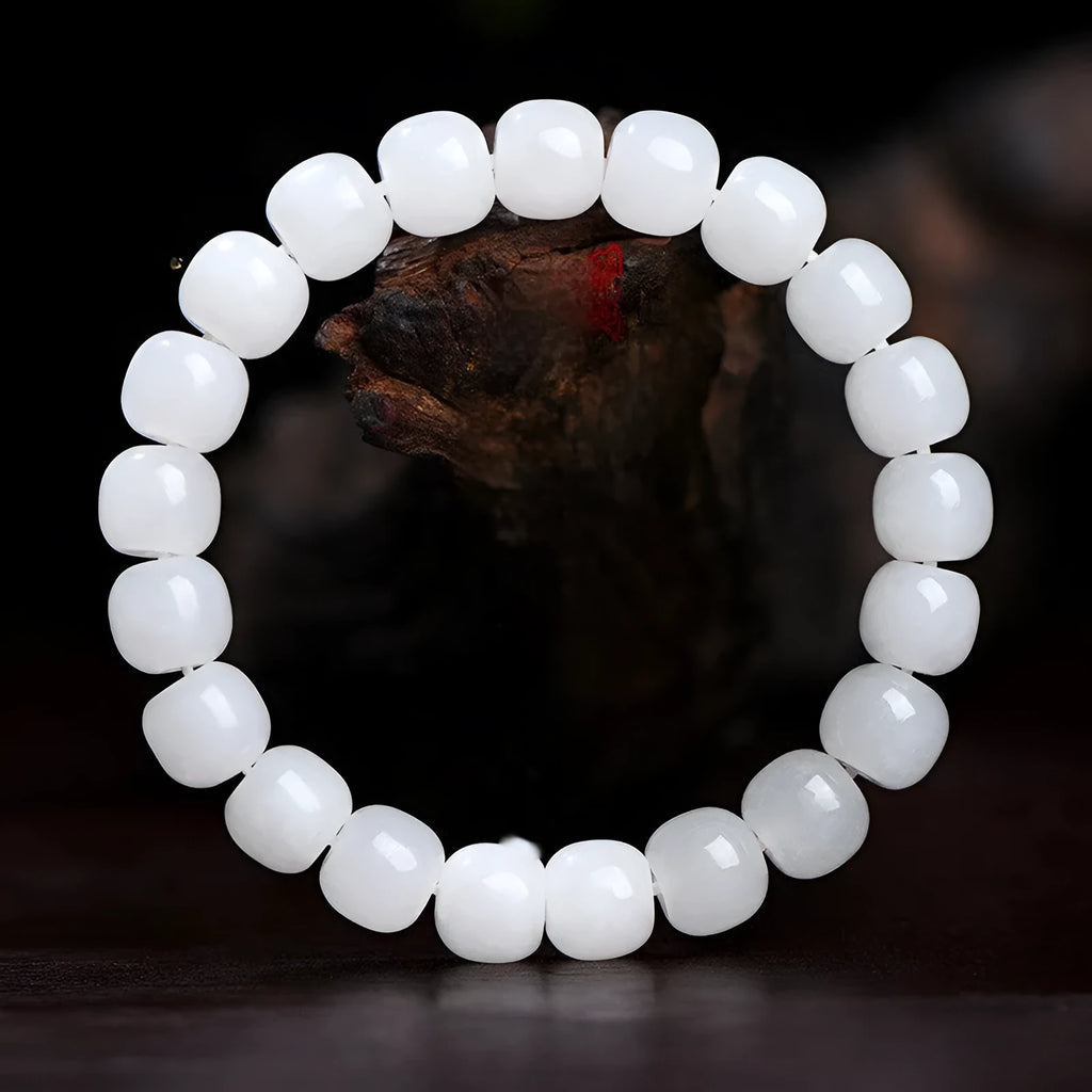 White Hetian jade barrel bead bracelet for men and women, shown in a casual style.