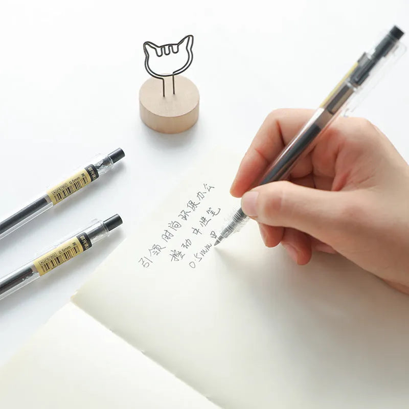 Twelve retractable gel pens with frosted black barrels and 0.5mm tips displayed with two refill units