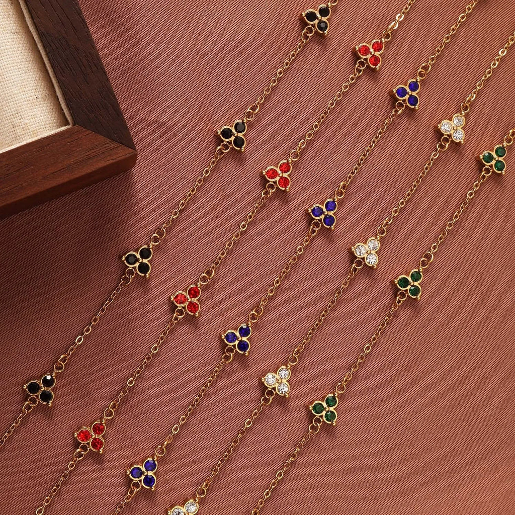Women's stainless steel geometric bracelet with three diamond triangle design and coloured stone accents