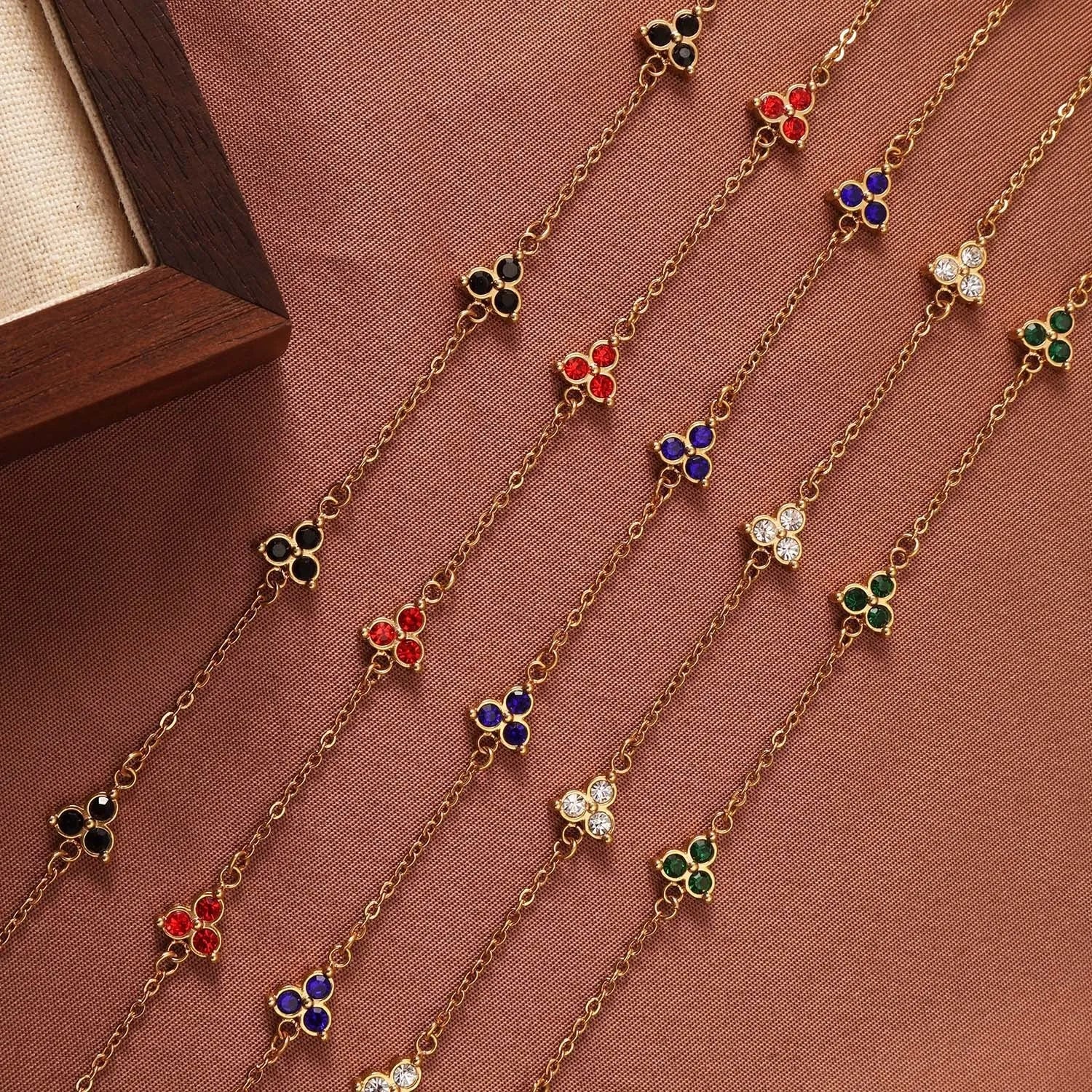 Women's stainless steel geometric bracelet with three diamond triangle design and coloured stone accents