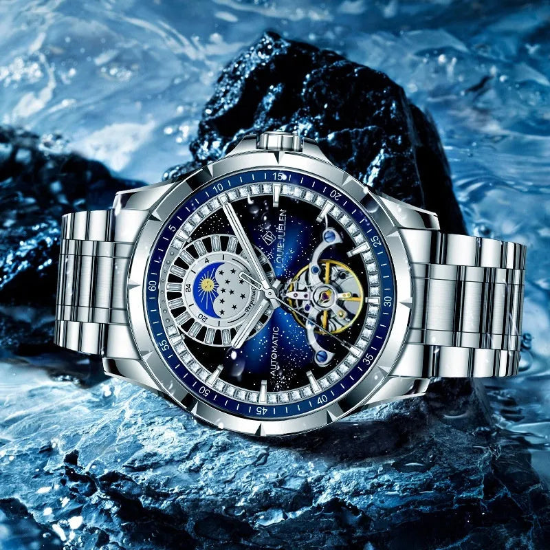 Men's silver alloy automatic mechanical watch with blue dial and stainless steel strap on wrist.