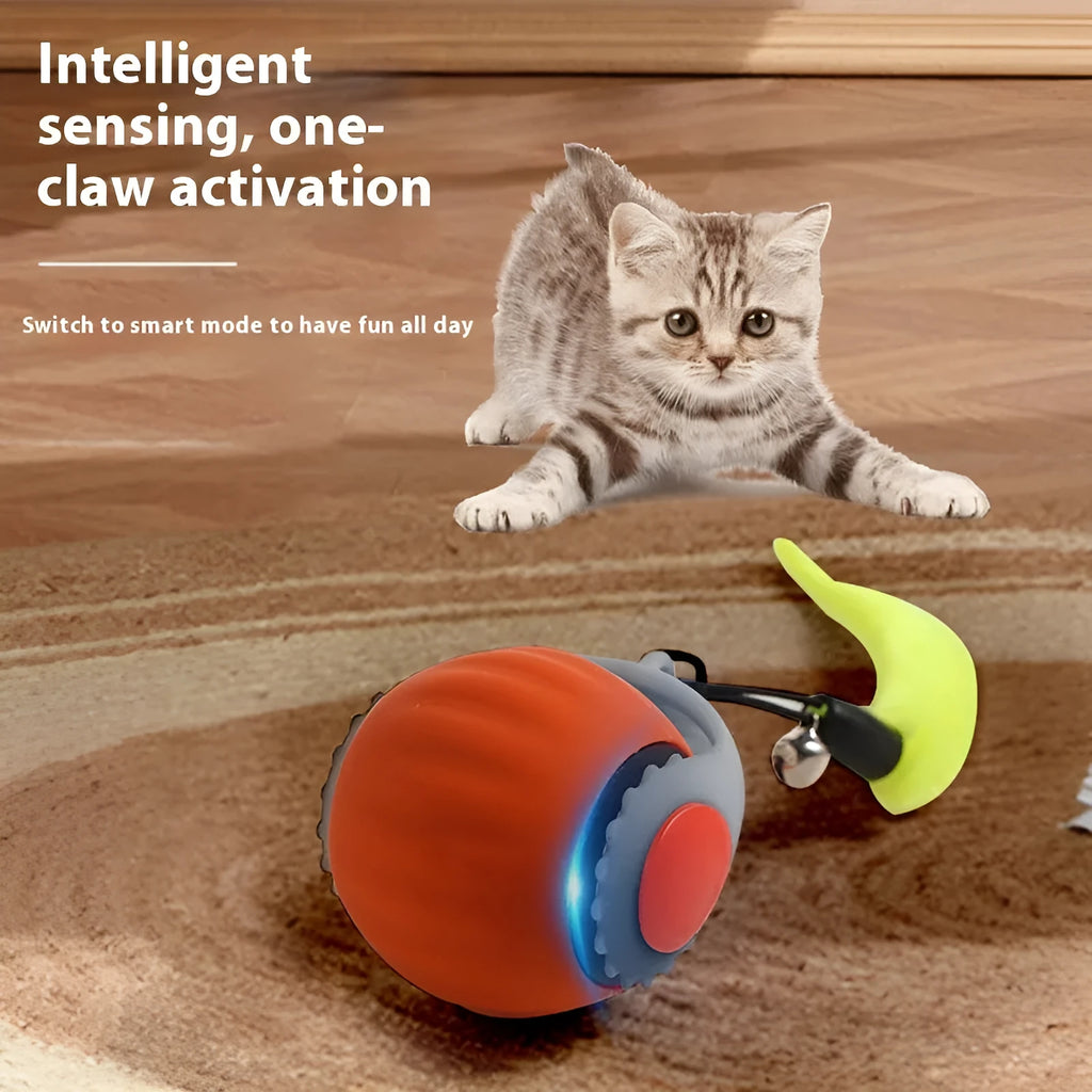 Orange and blue silicone gravity-powered cat toy with rolling ball and gun grip attachment options