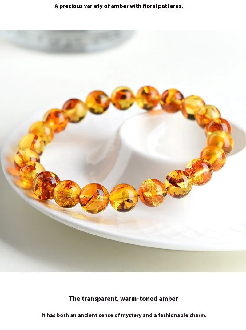 Natural yellow piebald amber bracelet with geometric beads on a wrist.