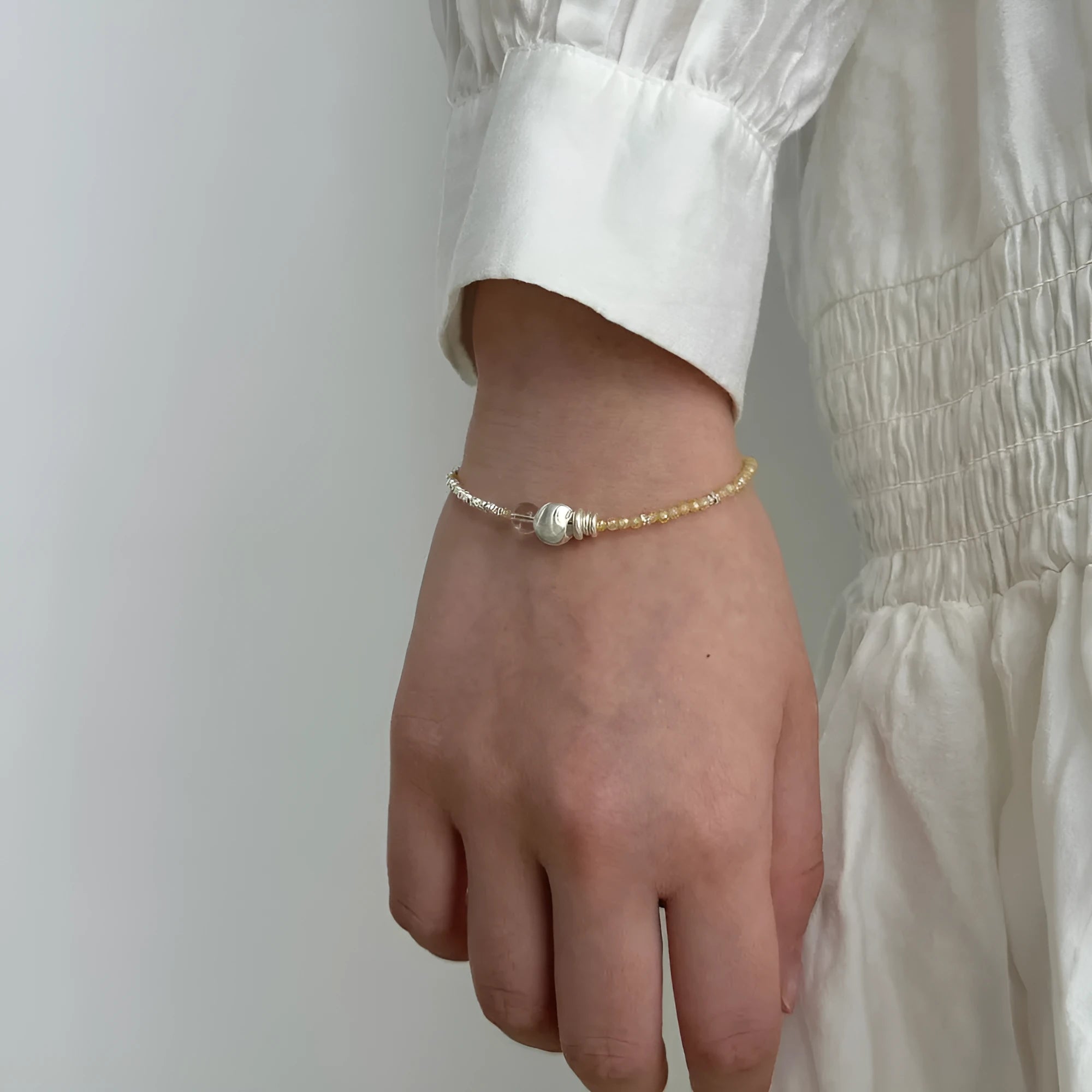 Women's 925 sterling silver brushed ball bead bracelet, round geometric design, electroplated silver finish, on neutral background