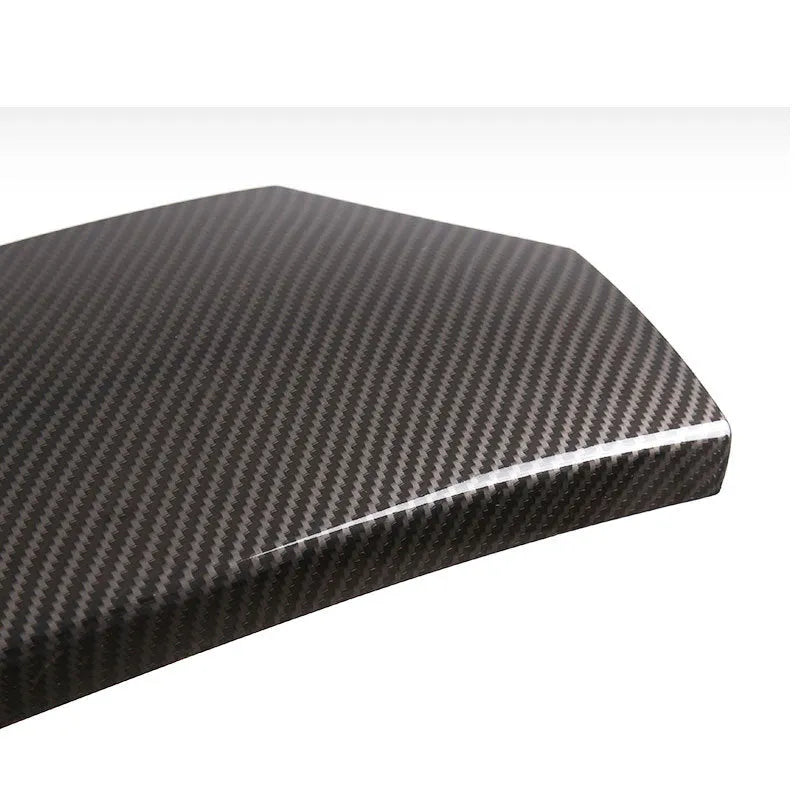 Set of three black ABS car armrest box protective covers with a diagonal carbon fibre weave pattern and shiny surface.