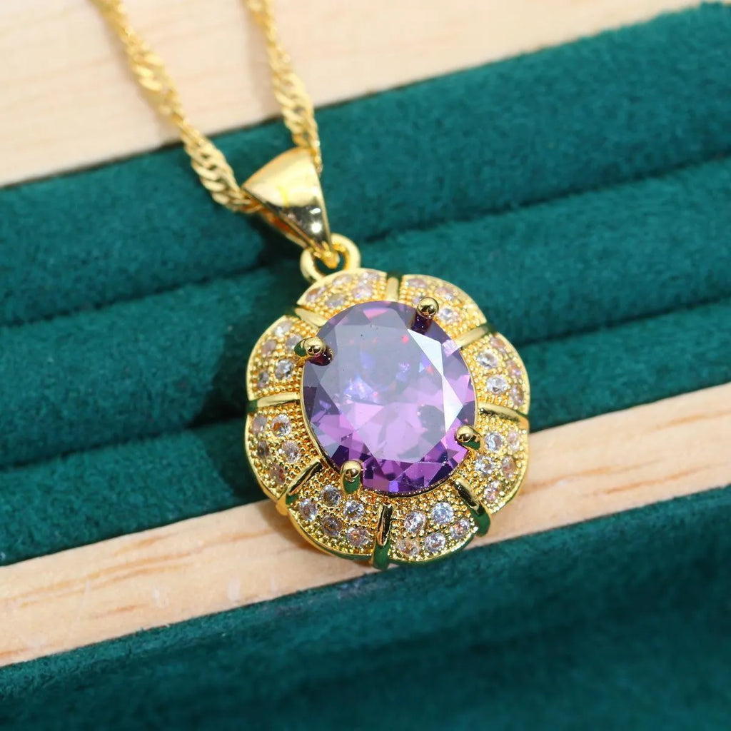 Gold plated necklace, earrings, bracelet, and ring set with blue cubic zirconia stones.