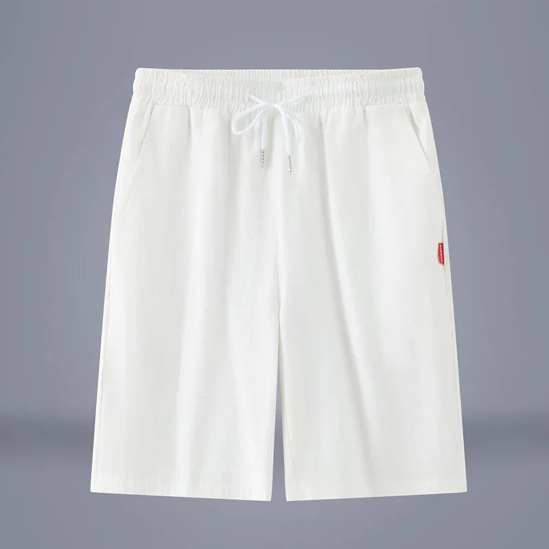 Solid colour cotton-linen cropped trousers with a drawstring waist on a hanger.