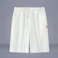 Solid colour cotton-linen cropped trousers with a drawstring waist on a hanger.