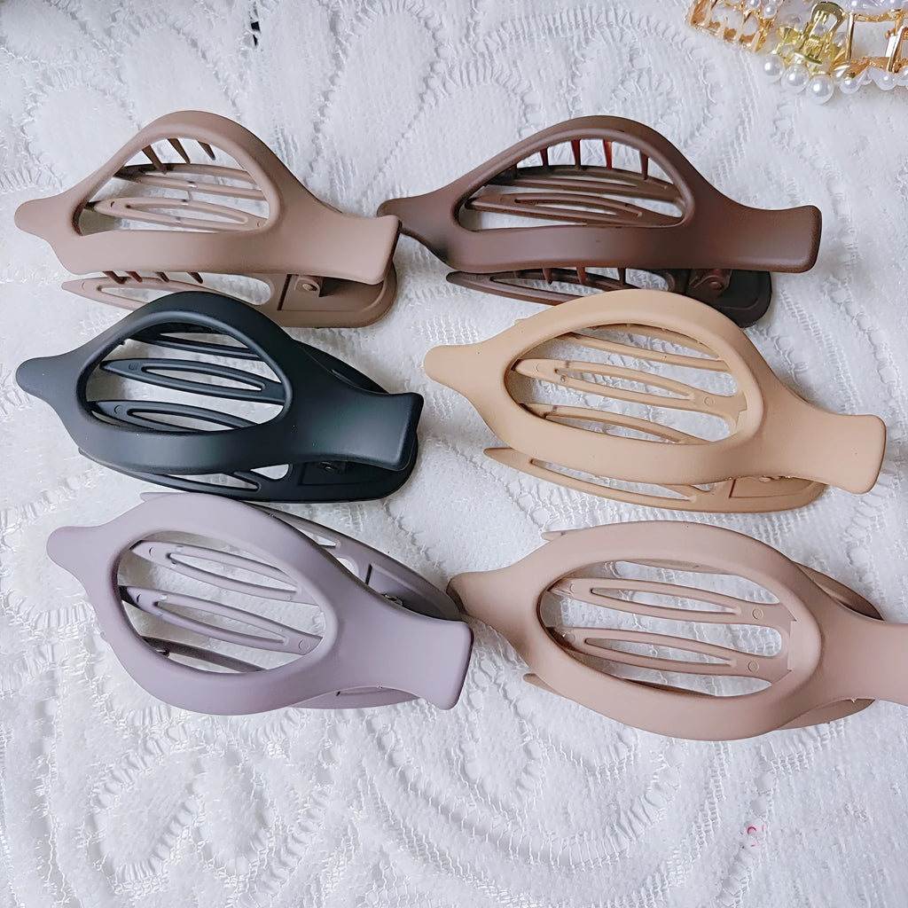 Six nude colour pointed toe hair clips with quadrilateral design and frosted plastic grips