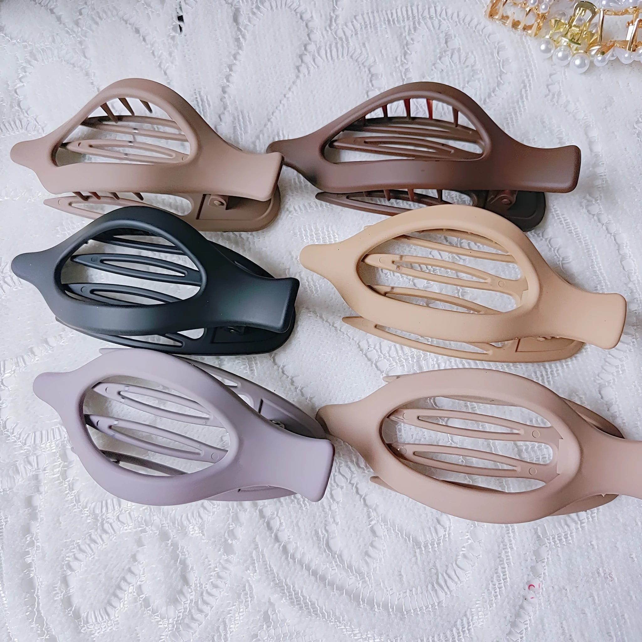 Six nude colour pointed toe hair clips with quadrilateral design and frosted plastic grips