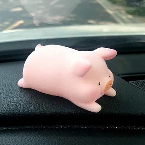 Set of eight cute cartoon pig resin car dashboard decorations on a car console