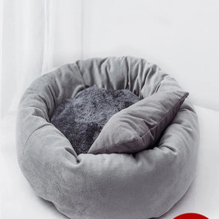 Soft light grey cotton-filled dog bed for a small dog, showing cloth material and round shape.