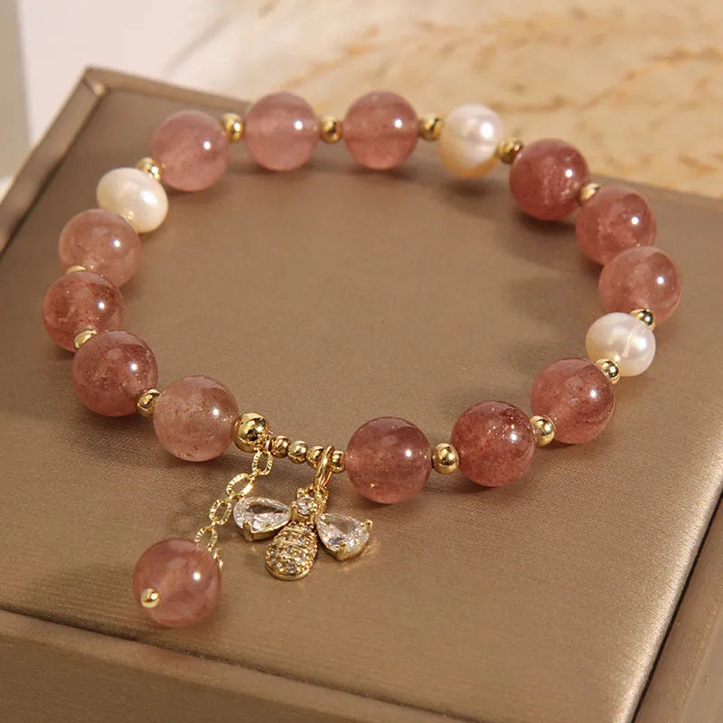 Women's bracelet with strawberry quartz beads, freshwater pearls, and zircon accents on an alloy setting.