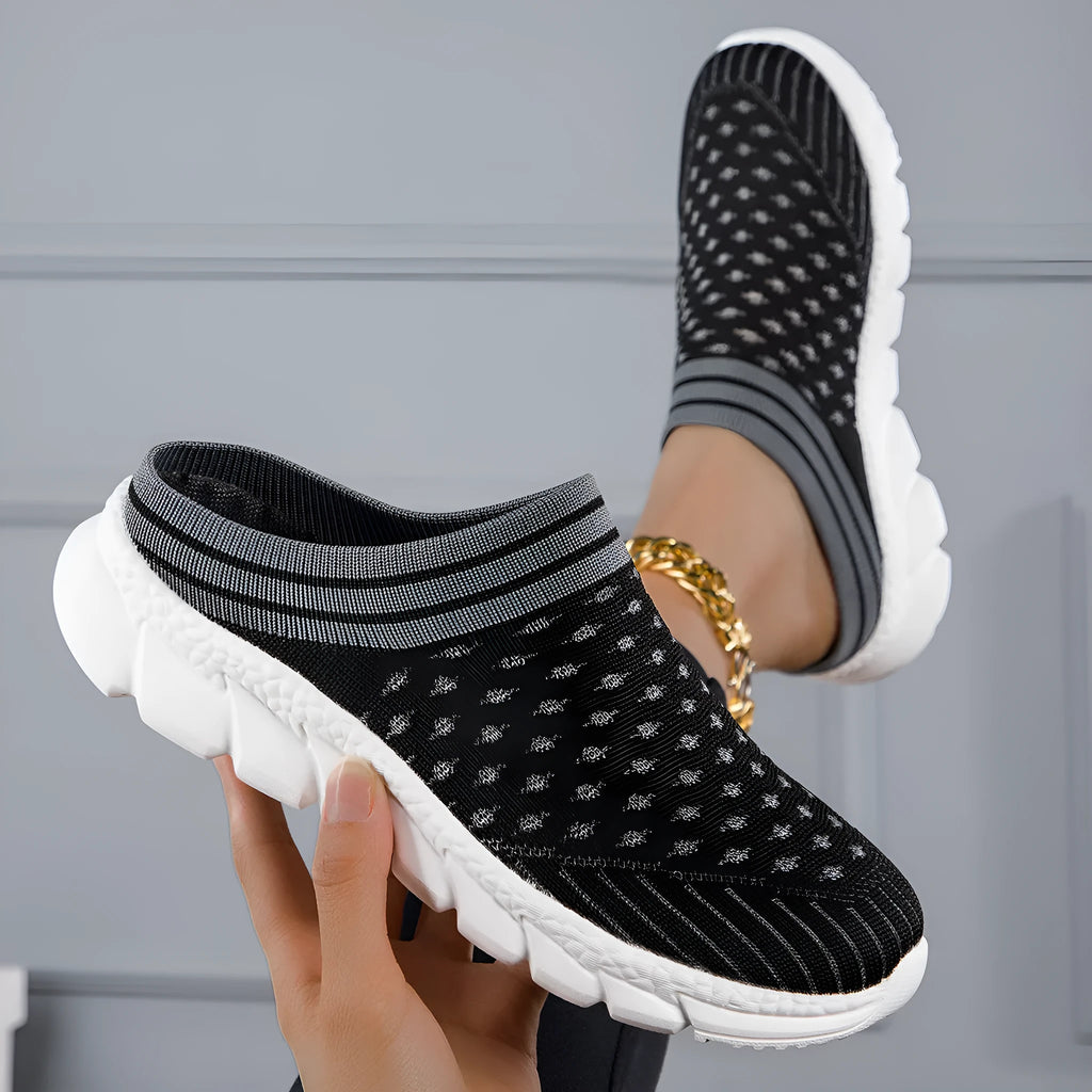Women's black striped Flyknit slipper shoes with hollowed-out design on a viscose sole.