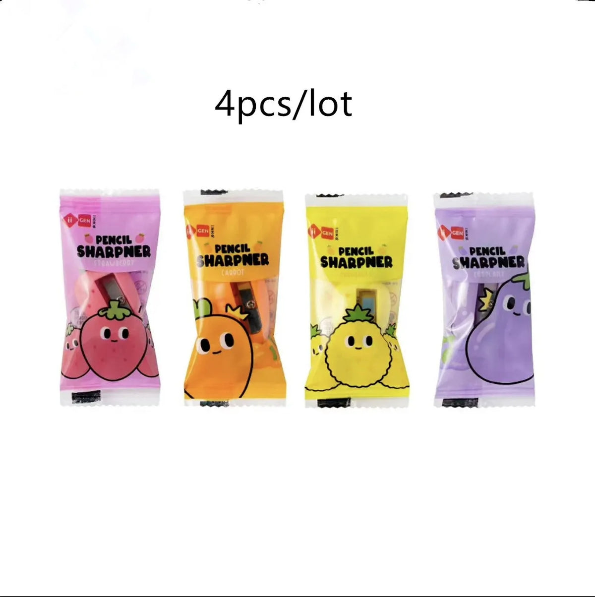 Four fruit and vegetable shaped mini pencil sharpeners in random colours on a light surface