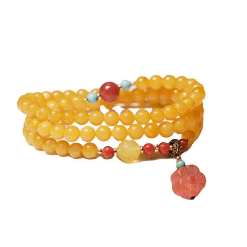 Women's retro-style amber bracelet with animal zodiac modelling in yellow chicken grease colour, 5mm round beads.