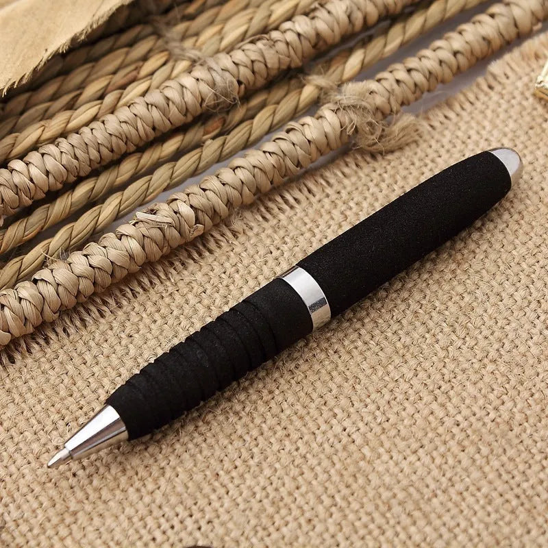Close-up of a silver EVA metal cap mini ballpoint pen with a 1.0 mm bullet tip, shown with a bright black refill.