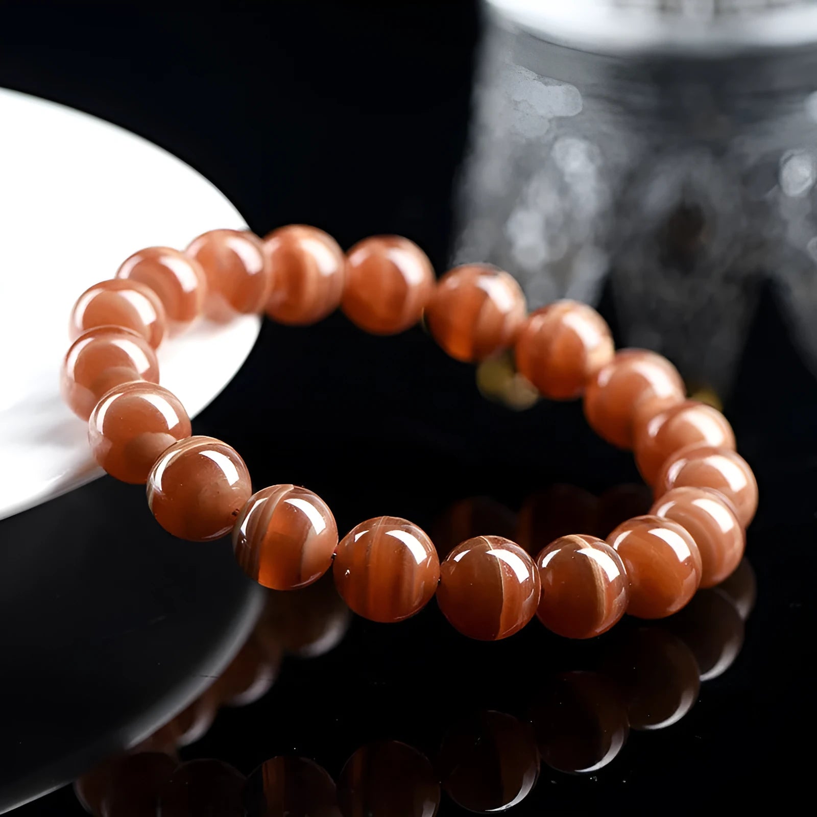 Natural old mine rhodochrosite round bead bracelet with Ruyi charm, shown in 6mm and 8mm sizes.