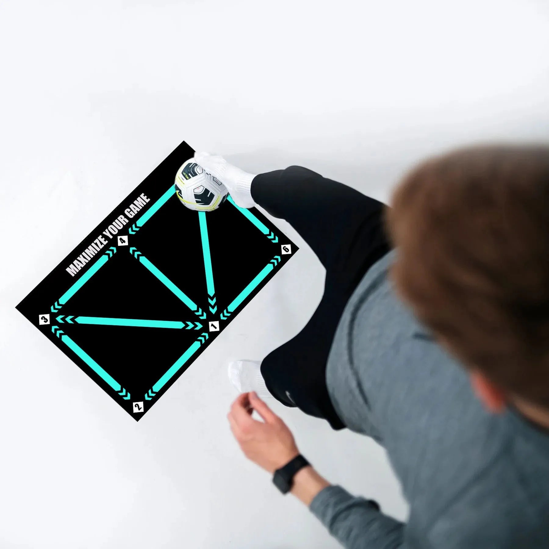 Black non-slip football training mat measuring 60 by 90 centimetres laid flat.