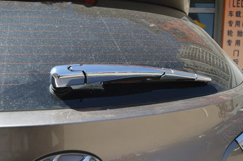 Four silvery ABS plastic rear window wiper cover trims for a 2010 Hyundai.