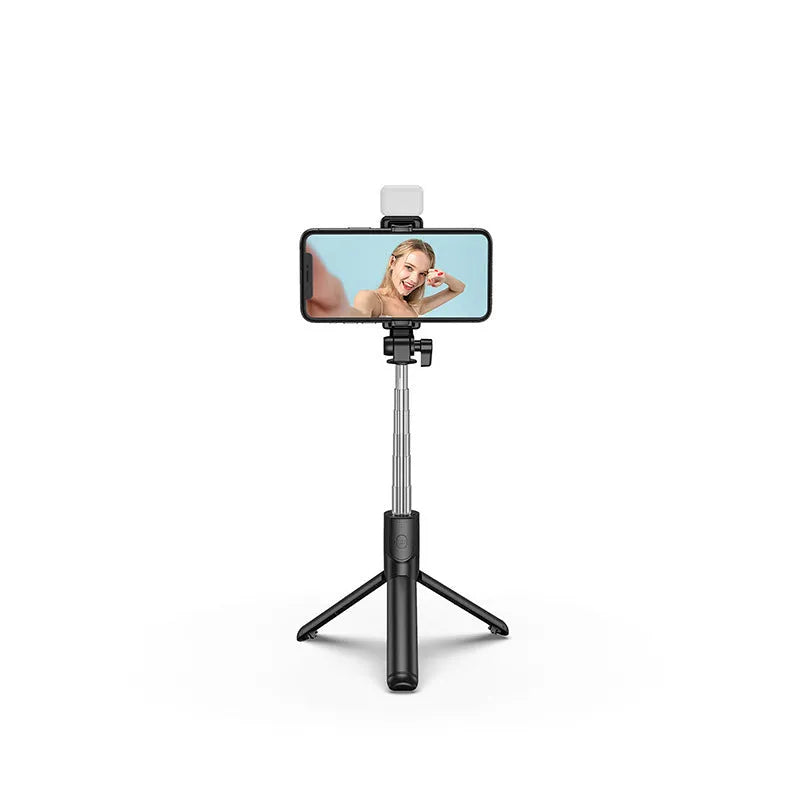 Black Bluetooth selfie stick with integrated tripod and 360-degree rotating phone holder, shown with a remote control.