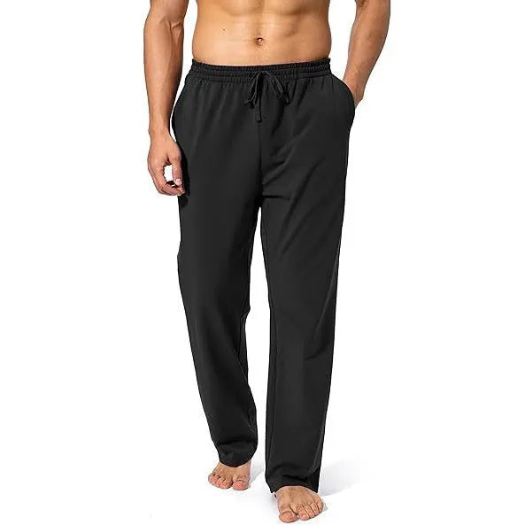 Men's loose fit casual trousers in black polyester fabric on a hanger.