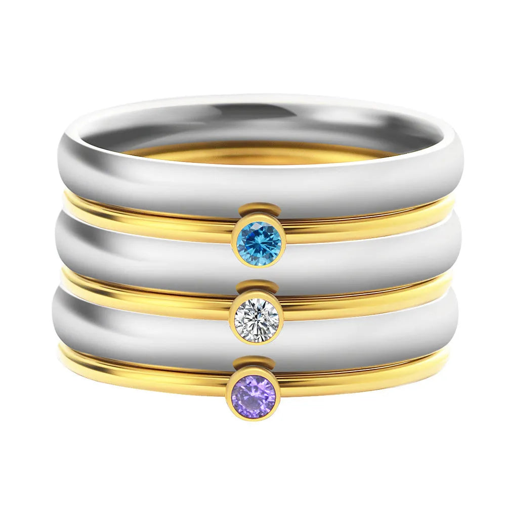 Geometric titanium steel ring with December birthstone colour and engraved gold lettering on band.
